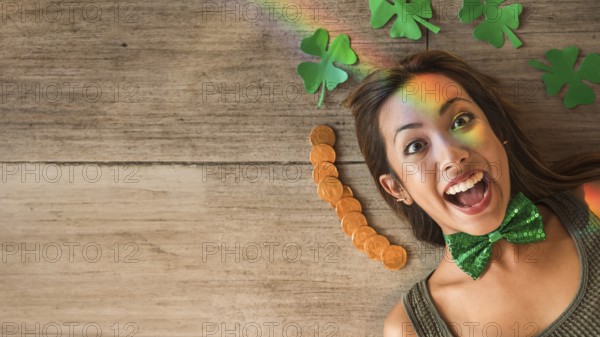 Crying woman near heap coins paper clovers floor