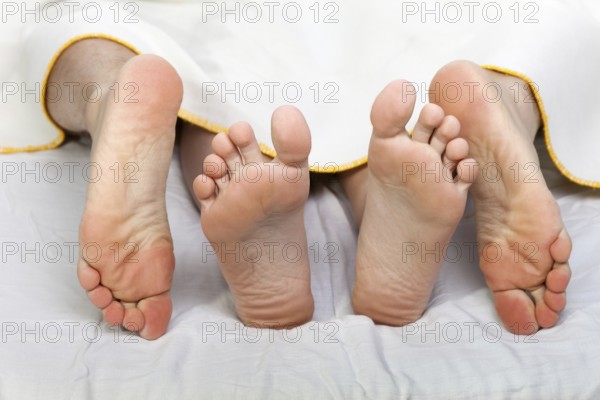 Human sex, men and women couple naked foot on bed