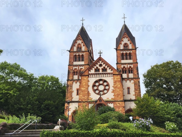 St. Lutwinuskirche in Mettlach is a Catholic parish church built in neo-Gothic style. The church has two towers and a rose window. Mettlach, Merzig-Wadern, Saarland, Germany, Europe