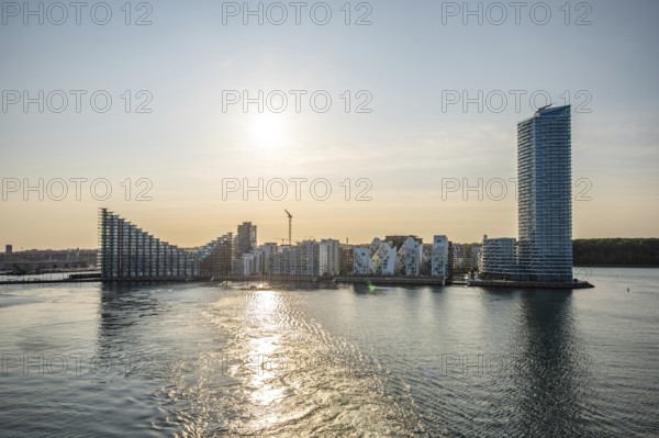 Modern futuristic Buildings and skyscraper of Aarhus Skyline Denmark with sea in front during sunset
