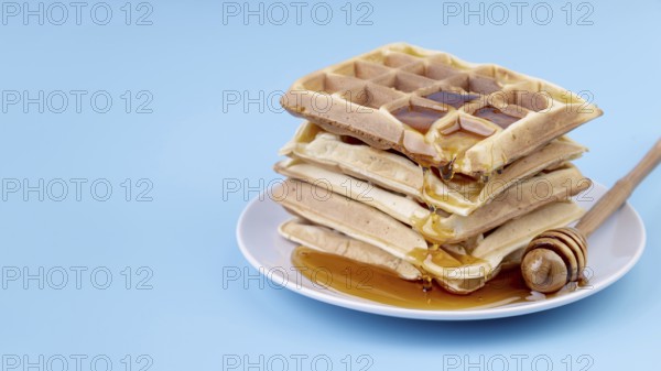 High angle honey covered stacked waffles plate with copy space