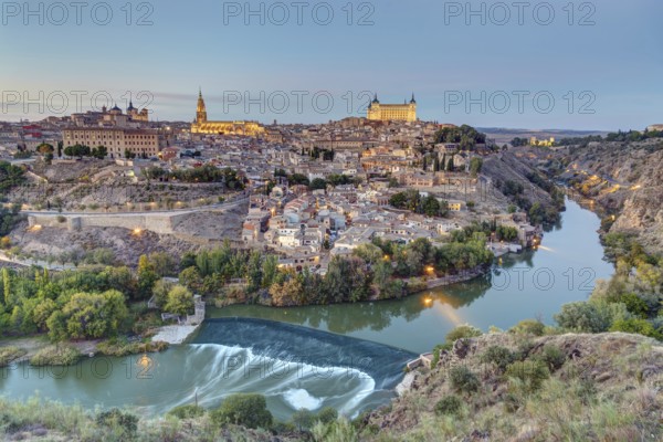 The old town of Toledo with the Tagus River at dusk