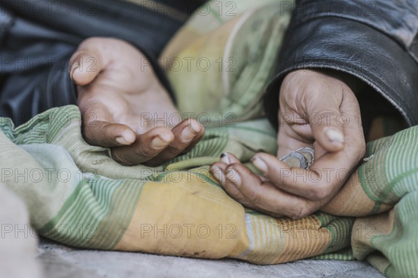 Homeless woman holding hands out for help