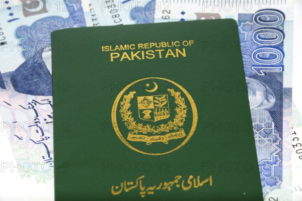 A Pakistani Passport on Currency notes in Pakistani Rupees