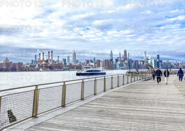 Domino Park waterfront promenade, Williamsburg, with a view across the East River to the Manhattan skyline, New York City, USA, North America