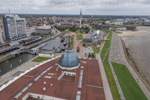 Overview of a modern city with river, buildings and green areas on a cloudy day, bremerhaven, germany