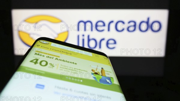 Stuttgart, Germany, 06-25-2022: Smartphone with webpage of Argentine e-commerce company Mercado Libre Inc. on screen in front of logo. Focus on top-left of phone display, Europe