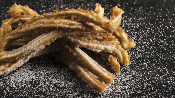 Delicious fried churros with sugar high view. High resolution photo