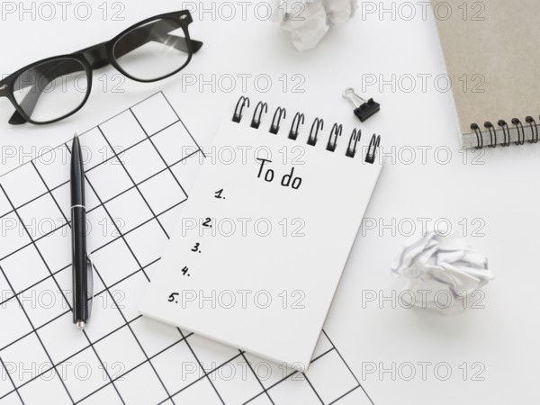 High angle list notepad with glasses pen