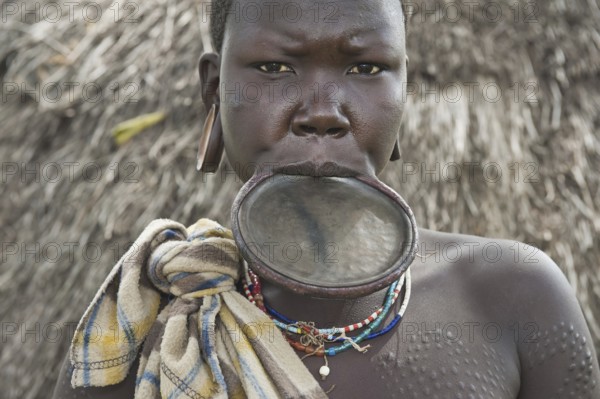 Surma woman with round lip plate, lip plate, Kibish, Omo Valley, Ethiopia, Africa