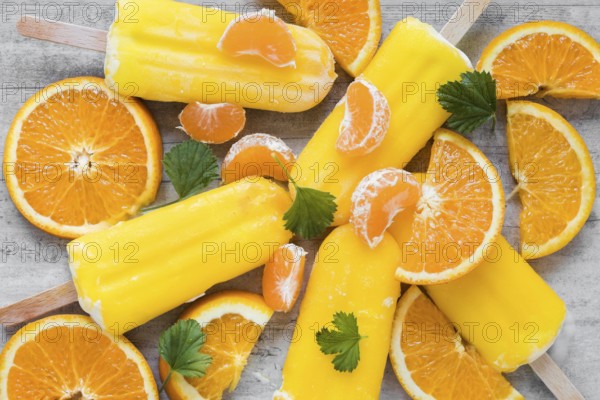Top view yummy popsicles with orange mint