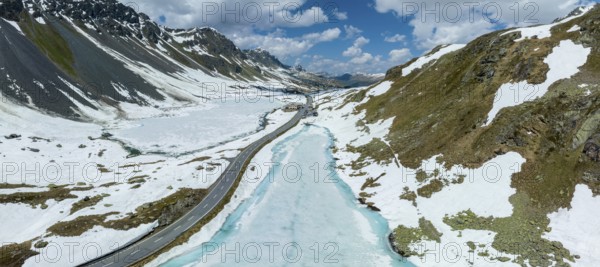 Switzerland, graubünden, flüela, flüelapass, pass, alps, mountain, mountains, mountain pass, drone, drone photo, drone image, aerial photo, aerial photography, snow, residual snow, road, car road, car, car traffic, tourism, travel, pass height, restaurant, lake, ice, thaw, melt, turquoise, Europe