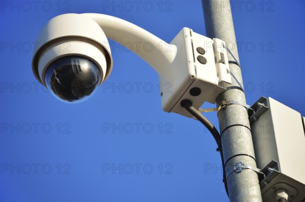 Hi-tech dome type camera over a blue sky