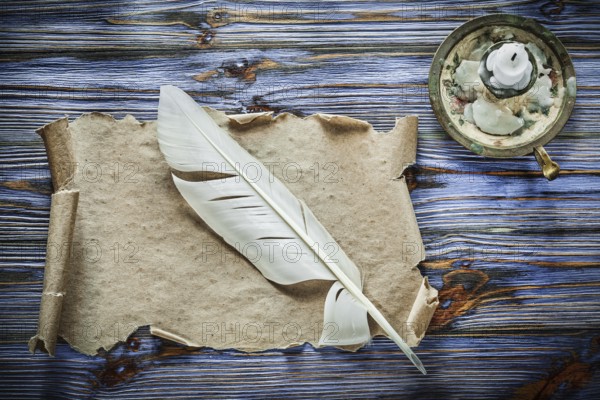 Vintage paper scroll feather chandelier on blue wooden background