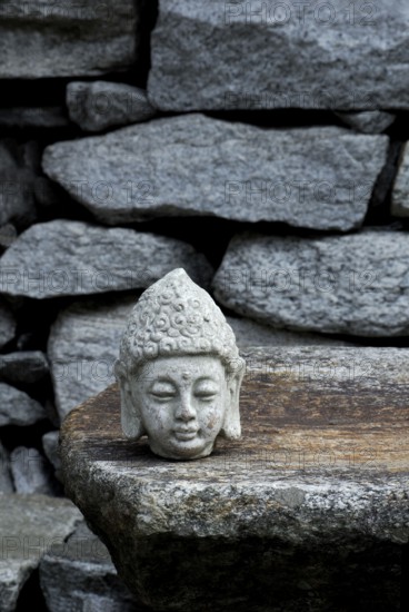 Buddha head on stone slab