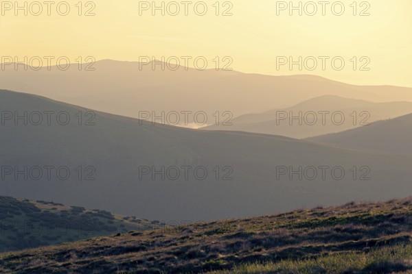 Morning atmosphere at Papusa Peak above the mountains of the Fagaras Mountains, also called Fogarasch Mountains, in the Southern Carpathians. Transalpina High Road, Valcea, Romania, Southeast Europe, Europe