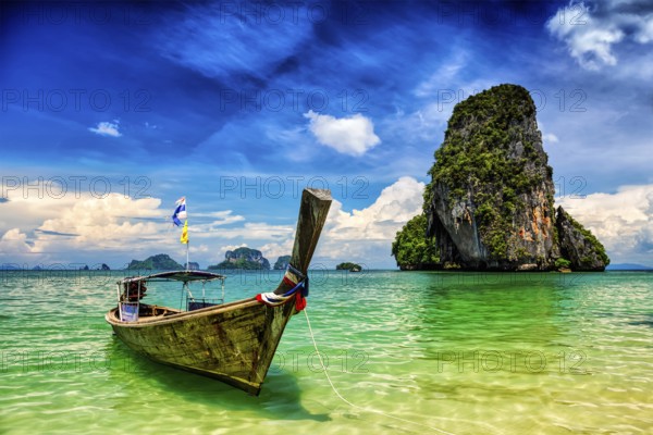 Long tail boat on tropical beach (Pranang beach) and rock, Krabi, Thailand, Asia