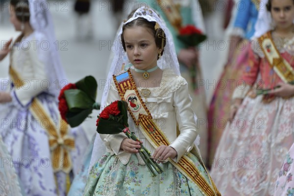 Fallas festival, girls in a traditional costume during the parade in the Plaza de la Virgen de los Desamparados, Valencia, Spain, Europe
