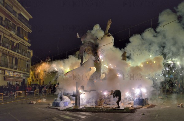 A burning Falla, a papier-mâché figure, at the Falles or Fallas spring festival, Pego, Province of Alicante, Spain, Europe