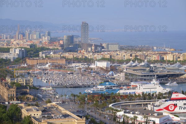 BARCELONA, SPAIN, APRIL 15, 2019: Aerial view of Barcelona city skyline with city traffic and port with yachts and ferry ships. Barcelona, Spain, Europe