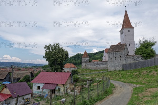 The fortified church of Sarosch, Brasov County, in Transylvania. The Gothic hall church was surrounded by a wall for defensive purposes. Sarosch, Transylvania, Romania, Southeast Europe, Europe