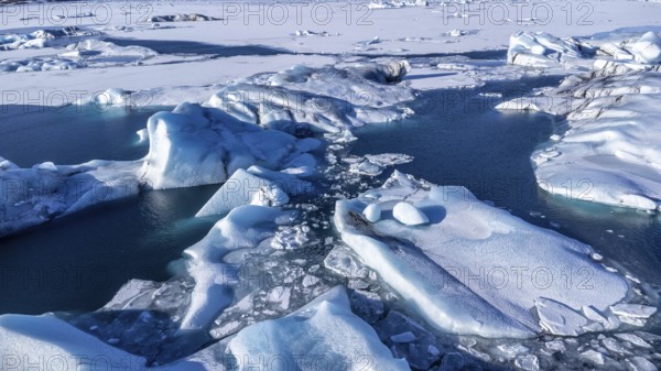 Aerial drone view of floating icebergs in Jokulsarlon glacier lagoon in Iceland