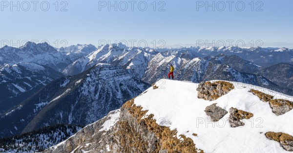 Ski tourers at the summit of Schafreuter, view of snowy mountain panorama, Karwendel, Tyrol, Austria, Europe