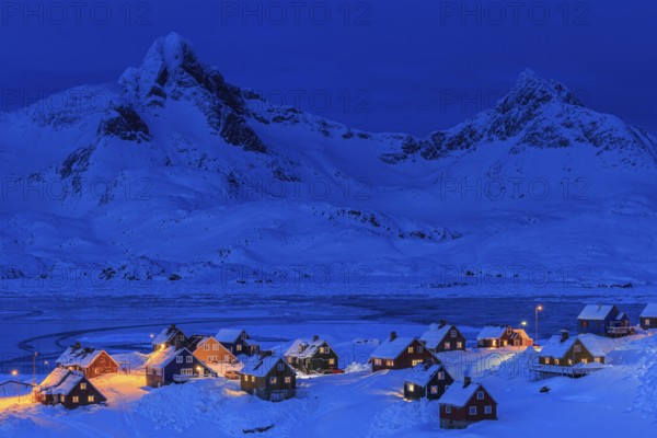 Inuit settlement, houses in deep snow in front of mountains, blue hour, twilight, winter, Tasiilaq, East Greenland, Greenland, North America