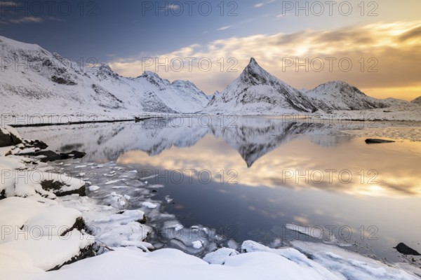 Snowy landscape with mountains and fjord, Volandstinden mountain, Fredvang, Flakstadøya, Lofoten, Norway, Europe