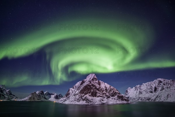 Green northern lights reflected in fjord, steep mountains, aurora borealis, winter, Reine, Moskenesoya, Lofoten, Norway, Europe