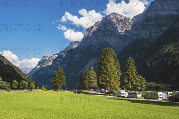 Vorauen campsite on the shores of Lake Klöntal with the Glärnisch Group rising up to 2915 metres, Klöntal, Canton Glarus, Switzerland, Europe