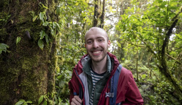 Young man in the rainforest, Monteverde cloud forest, Monte Verde, Puntarenas province, Costa Rica, Central America