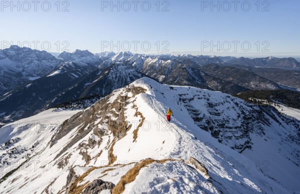 Ski tourers at the summit of Schafreuter, view of snow-covered mountain panorama, Karwendel, Tyrol, Austria, Europe