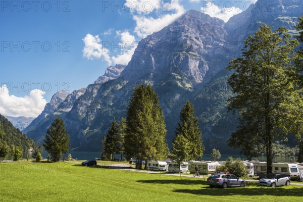 Vorauen campsite on the shores of Lake Klöntal with the Glärnisch Group rising up to 2915 metres, Klöntal, Canton Glarus, Switzerland, Europe