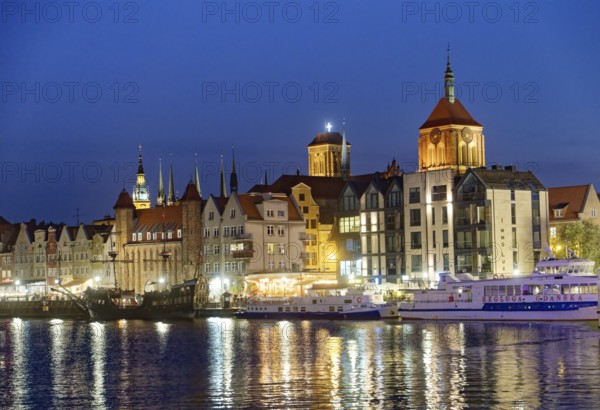 The harbour district on the Motlawa river, Motlawa, in the city centre of Gdansk, illuminated in the evening. Gdansk, Pomerania, Poland, Europe