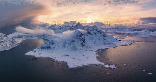 View of Flakstad and Skagsanden beach, snow-covered mountains and fjord at sunset, aerial view, Lofoten, Norway, Europe