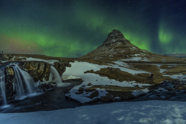 Beautiful Northern Lights on the picturesque Kirkjufell mountain in winter Iceland. Aurora Borealis concept