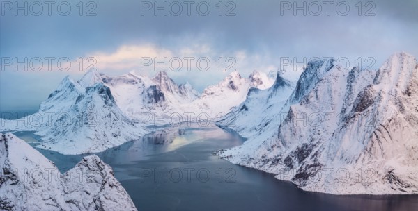 View of snow-covered mountains and fjord, Reinefjord, Lofoten, Norway, Europe