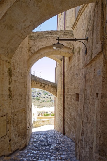 Paths and corridors in the tuff of the Sassi Barisano in the cave town of Matera. The cave settlements, Sassi, are a UNESCO World Heritage Site. Matera, Basilicata, Southern Italy, Southern Europe
