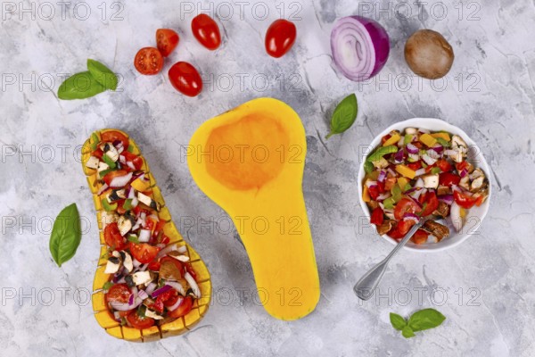 Top view of vegan baked Butternut squash vegetable filled with bell pepper, cherry tomatoes, red onion and mushrooms