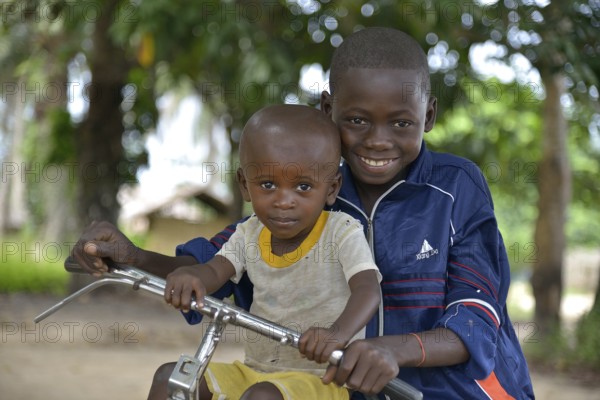 Two children with a bicycle, Nkala, Bandundu Province, Democratic Republic of the Congo