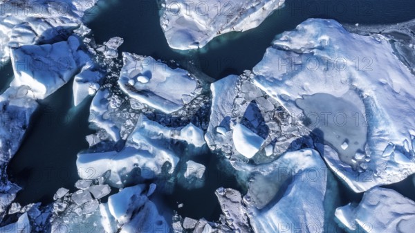Aerial drone view of floating icebergs in Jokulsarlon glacier lagoon in Iceland, top view