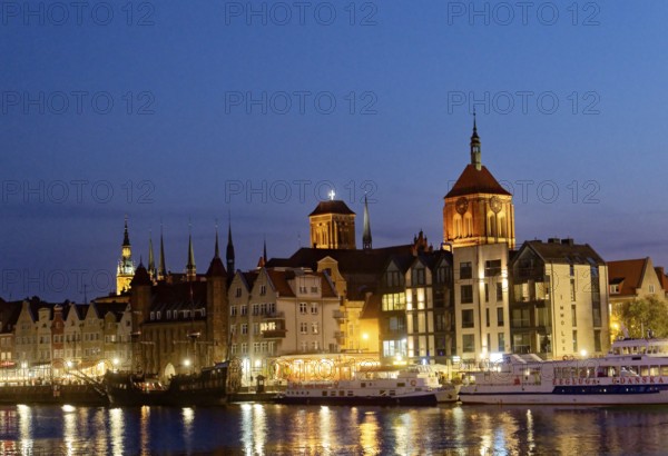 The harbour district on the Motlawa river, Motlawa, in the city centre of Gdansk, illuminated in the evening. Gdansk, Pomerania, Poland, Europe