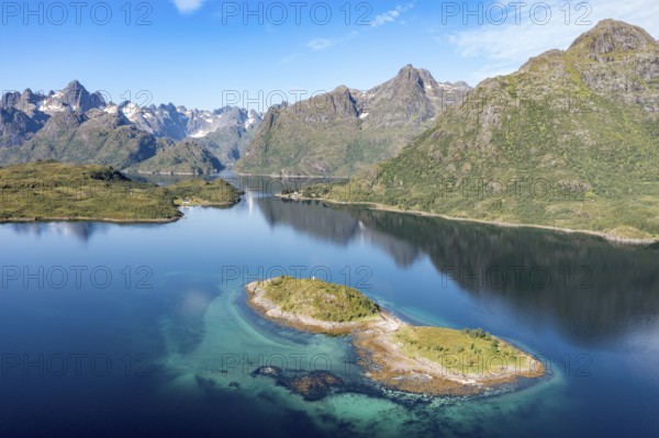Aerial view over fjord Raftsund, the waterway between Lofoten and Vesteralen island, island Rognholman in front, entry to famous Trollfjord in the back left, Norway, Europe