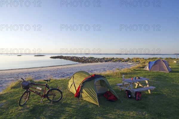 Camping on a quiet beach at dusk with tent, bike and picnic table, cycling holidays, adventure holidays, Bleik, Vesteralen, Langoya, Nordland, Norway, Europe