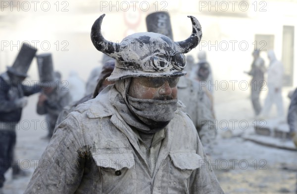 Man wearing viking helmet, Els Enfarinats flour fight, rebels, armed with flour, eggs and firecrackers, take over the regiment of the city for one day, Plaza de la Iglesia, Ibi, Province of Alicante, Costa Blanca, Spain, Europe