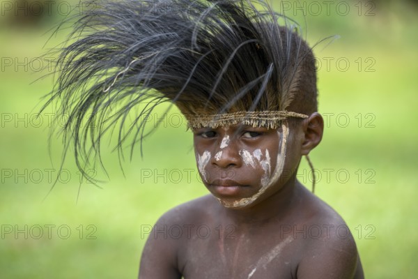 Native boy with cassowary feather headdress, village of Mutin, Lake Murray, Western Province, Papua New Guinea, Oceania