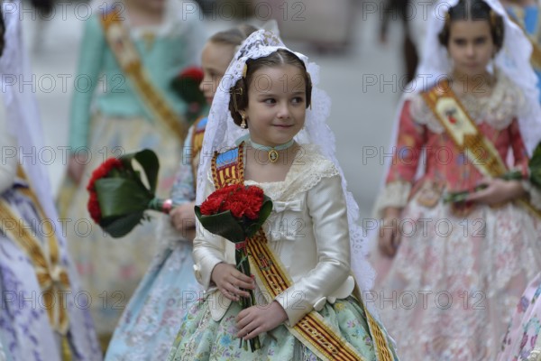 Fallas festival, girls in a traditional costume during the parade in the Plaza de la Virgen de los Desamparados, Valencia, Spain, Europe