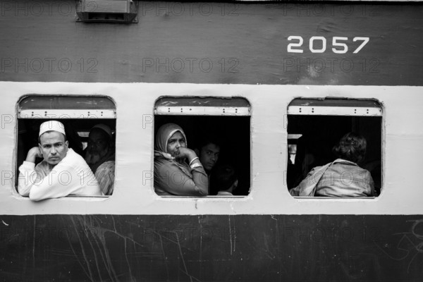 Passengers looking out of the window of a train, Monochrom, Dhaka, Bangladesh, Asia