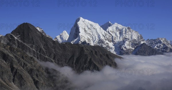 Sea of fog in the Gokyo Valley and peaks of Ama Dablam, Cholatse and Tobuche